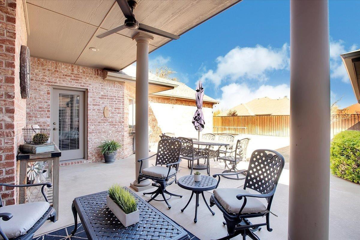 4818 104th Street Lubbock, TX 79424 - Photo 33 of 36 a view of a balcony with furniture and a floor to ceiling window