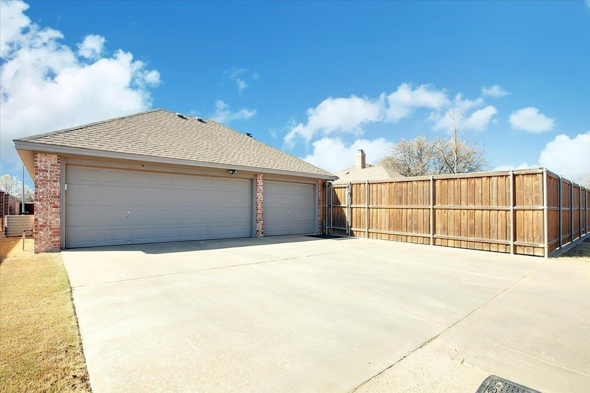 4818 104th Street Lubbock, TX 79424 - Photo 36 of 36 a front view of a house with a garage