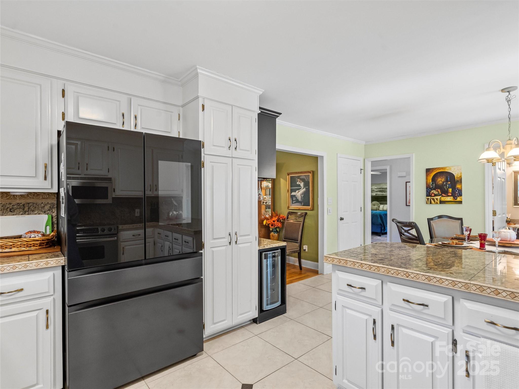 1002 4th Street Northeast Conover, NC 28613 - Photo 12 of 47 a kitchen with granite countertop a refrigerator and a sink