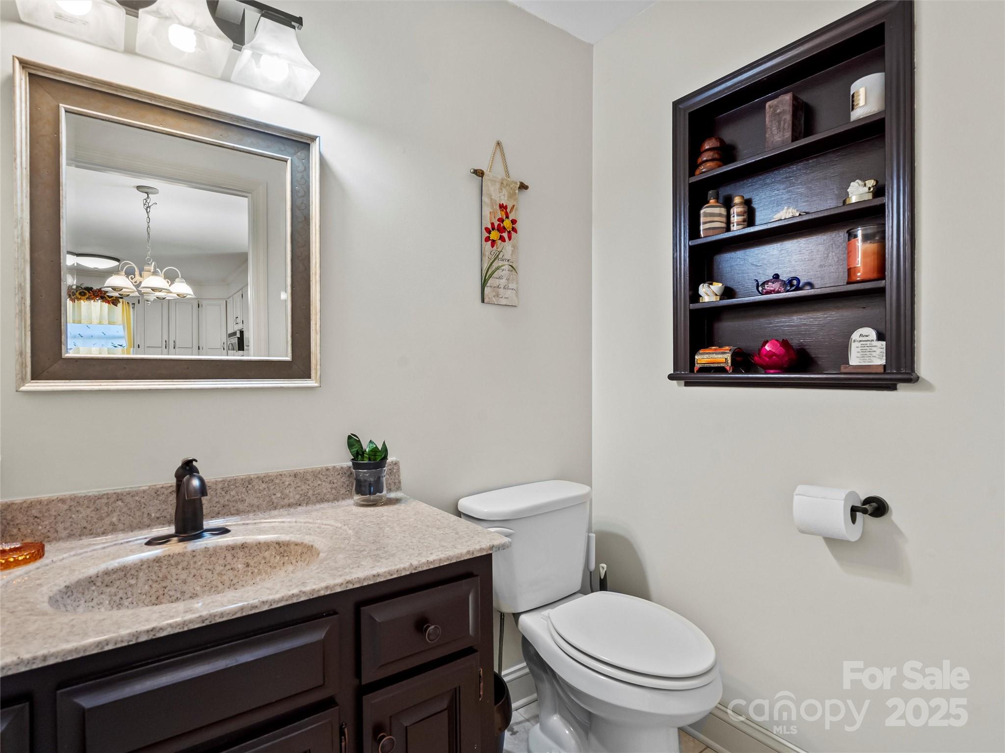 1002 4th Street Northeast Conover, NC 28613 - Photo 29 of 47 a bathroom with a toilet a sink and mirror