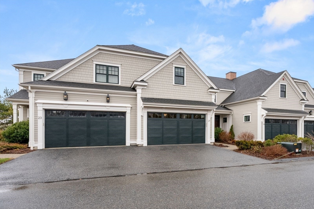 21 Lillian Way, Unit 21 Wayland, MA 01778 - Photo 1 of 33 a front view of a house with a yard and garage