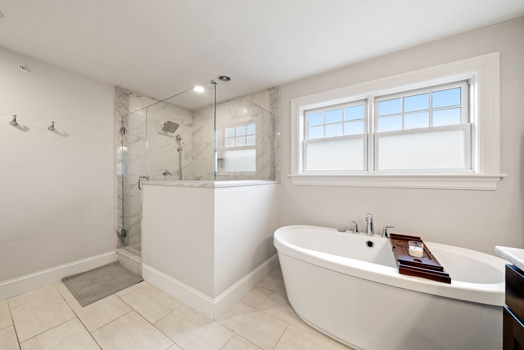 21 Lillian Way, Unit 21 Wayland, MA 01778 - Photo 15 of 33 a bathroom with a bathtub sink and mirror