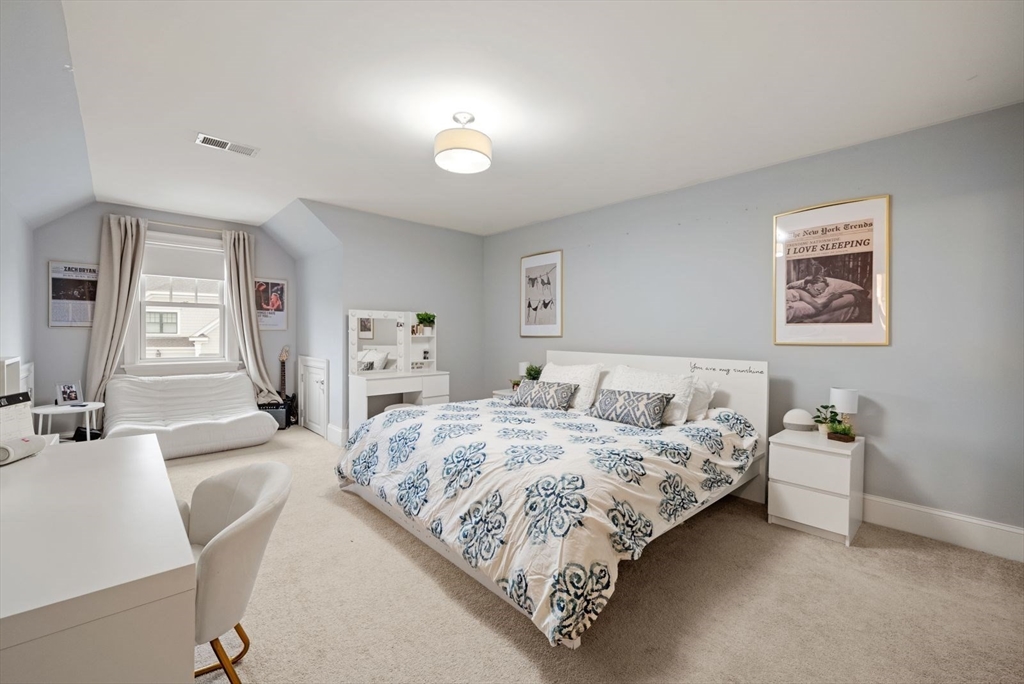 21 Lillian Way, Unit 21 Wayland, MA 01778 - Photo 26 of 33 a bedroom with a bed and a couch