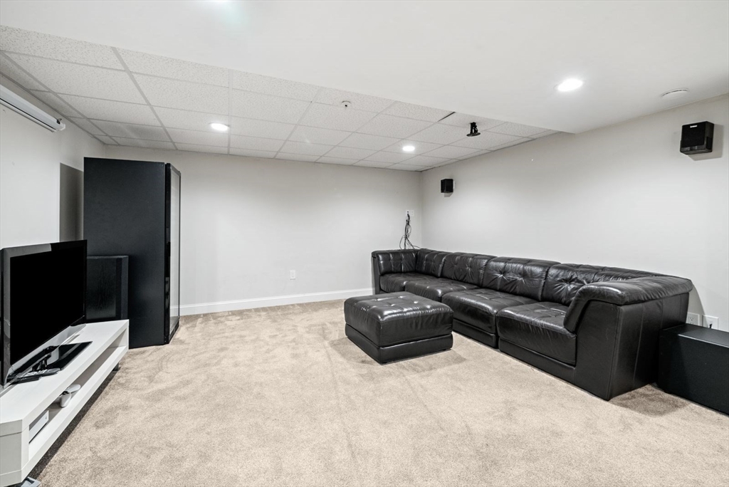 21 Lillian Way, Unit 21 Wayland, MA 01778 - Photo 29 of 33 a living room with furniture and a flat screen tv