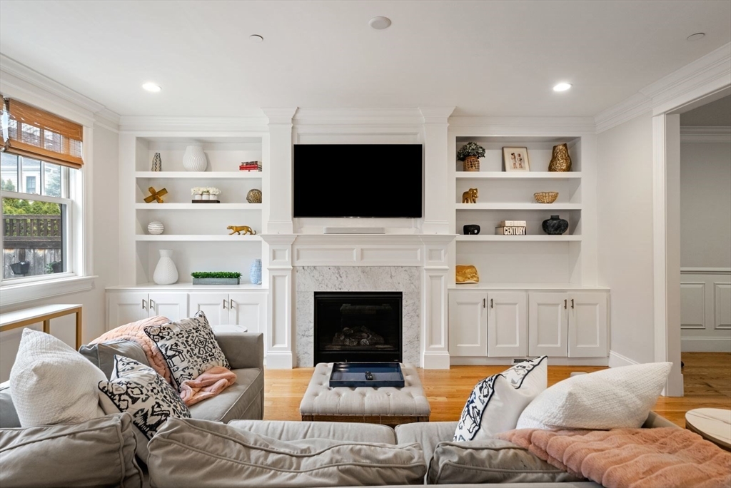 21 Lillian Way, Unit 21 Wayland, MA 01778 - Photo 7 of 33 a living room with furniture a flat screen tv and a fireplace