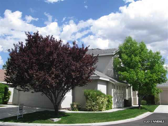 9665 Otter Way Reno, NV 89521 - Photo 1 of 1 a view of a white house next to a yard with big trees
