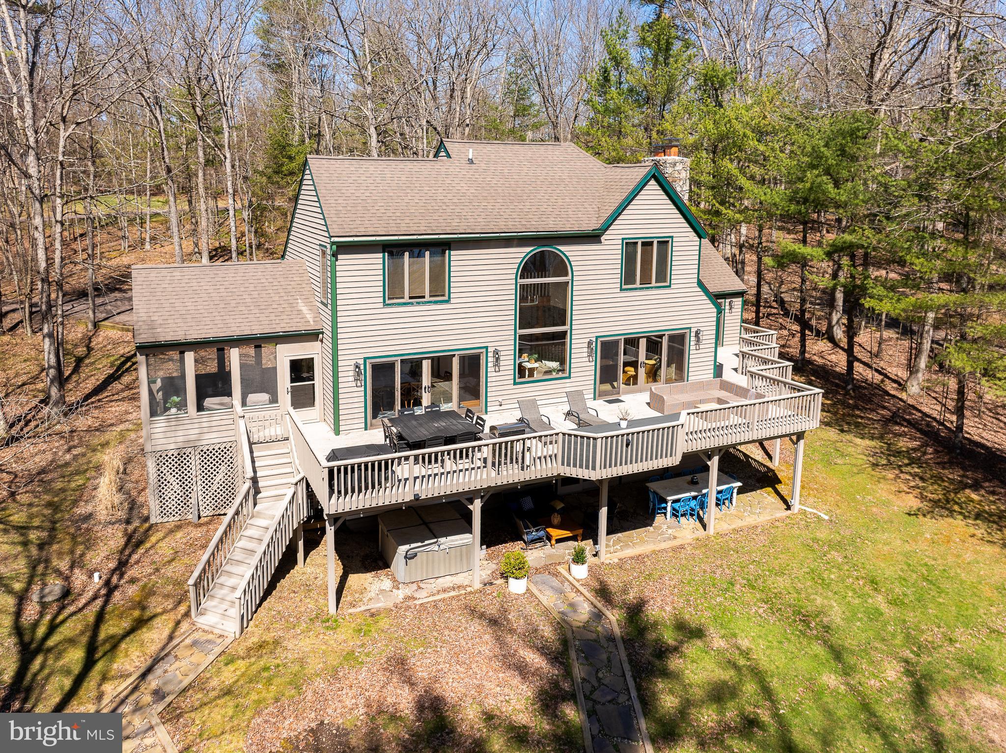 a aerial view of a house with swimming pool and sitting area
