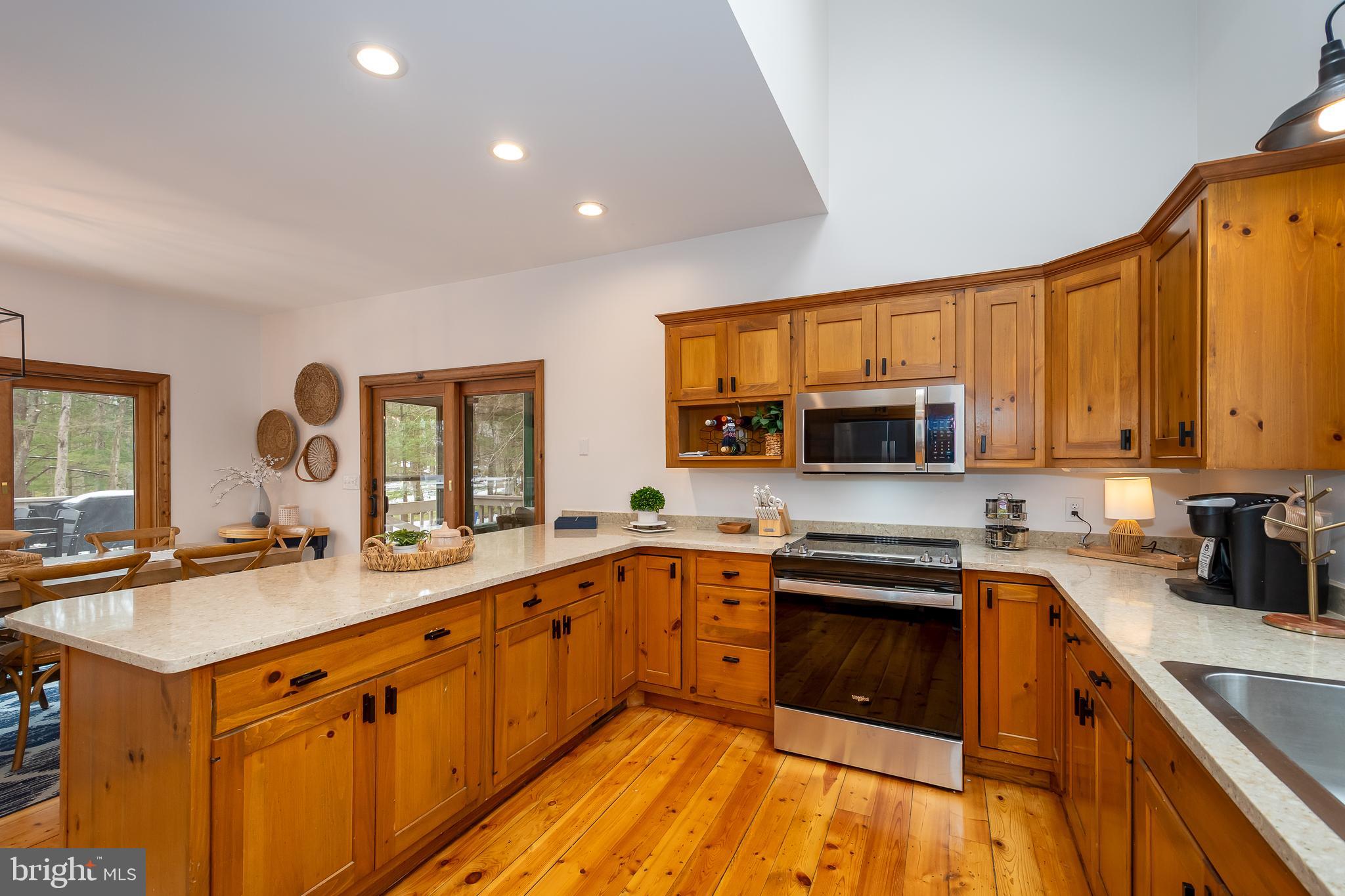 1038 South Blakeslee Road Oakland, MD 21550 - Photo 13 of 69 a kitchen with stainless steel appliances granite countertop a sink stove and cabinets