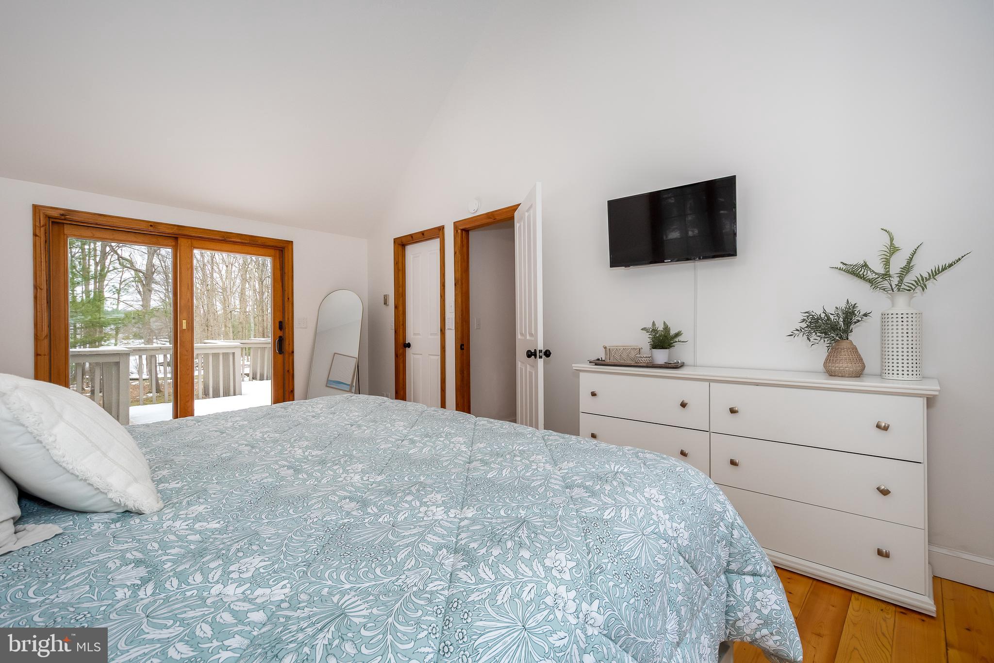 1038 South Blakeslee Road Oakland, MD 21550 - Photo 24 of 69 a bedroom with a bed and a flat screen tv
