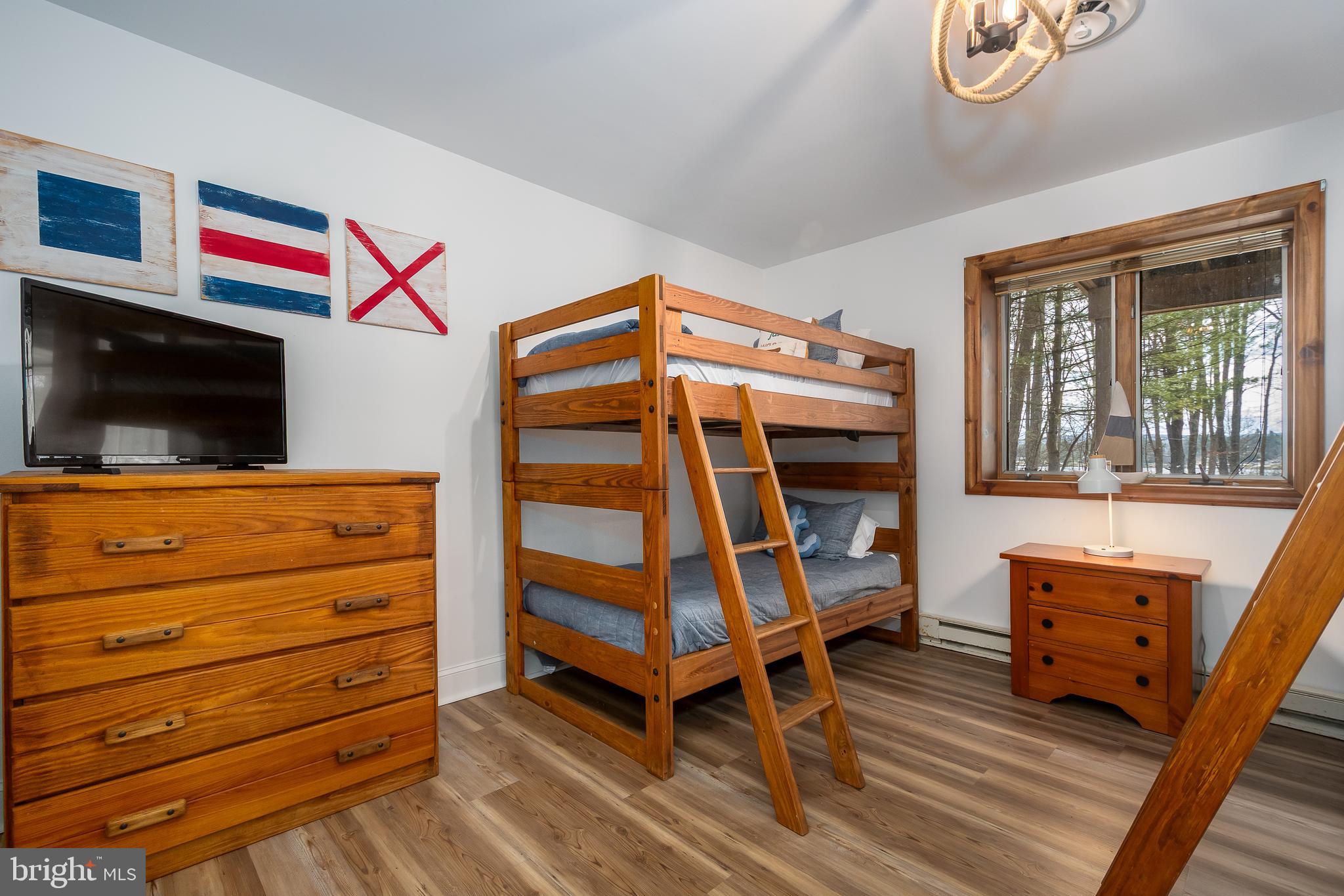 1038 South Blakeslee Road Oakland, MD 21550 - Photo 50 of 69 a bedroom with a bunk bed and a flat screen tv