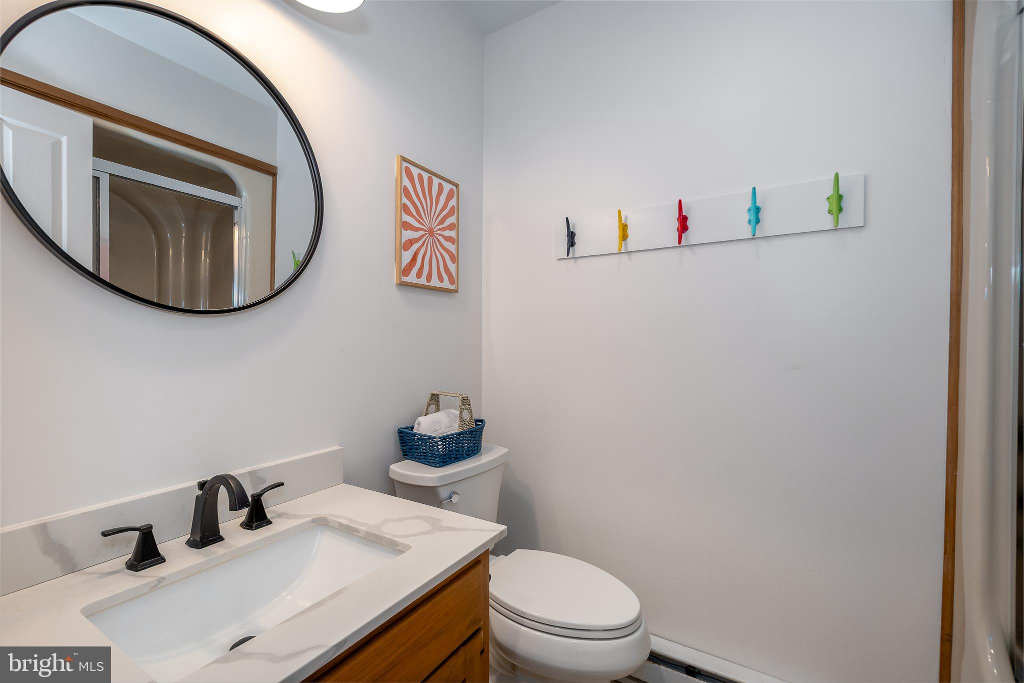 1038 South Blakeslee Road Oakland, MD 21550 - Photo 51 of 69 a bathroom with a toilet sink and mirror