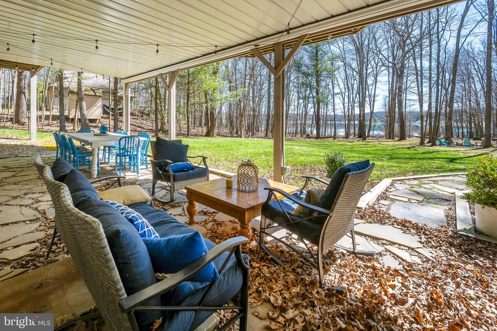 1038 South Blakeslee Road Oakland, MD 21550 - Photo 59 of 69 a view of a patio with couches chairs and a big yard