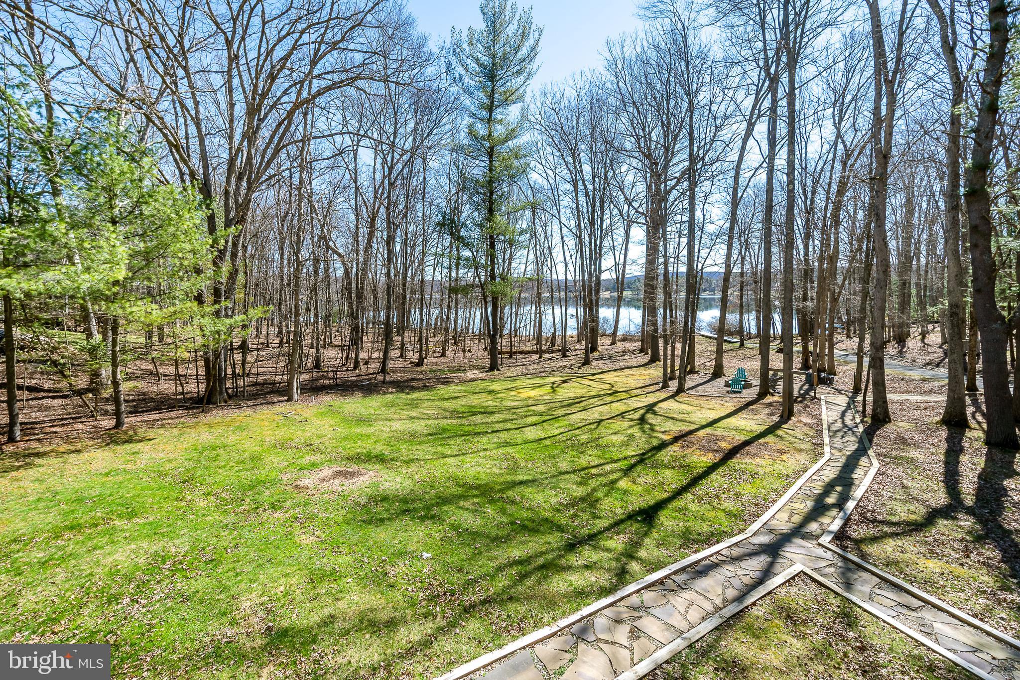 1038 South Blakeslee Road Oakland, MD 21550 - Photo 62 of 69 a view of a swimming pool with a bench and trees