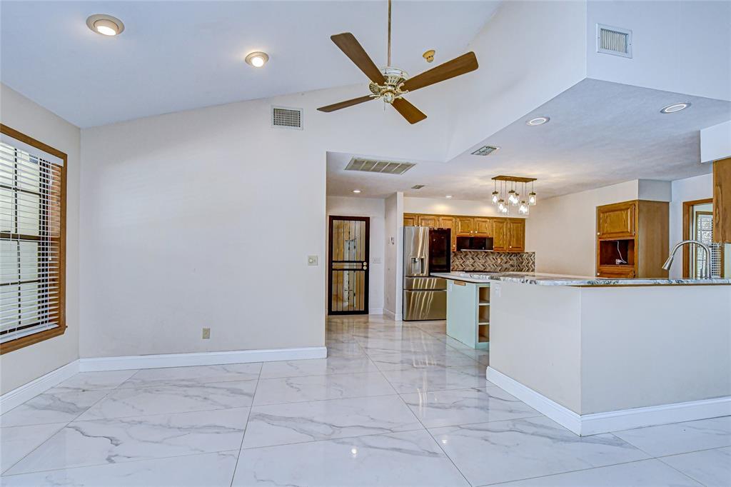 16349 Spring Valley Road Dade City, FL 33523 - Photo 17 of 40 a view of a kitchen with a sink and microwave