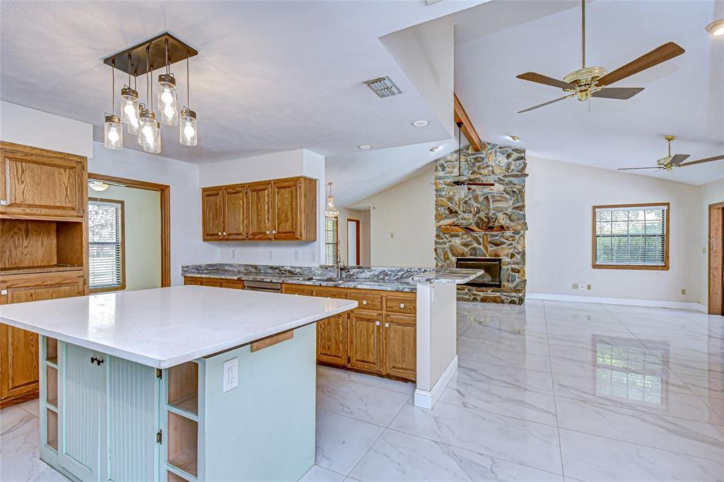 16349 Spring Valley Road Dade City, FL 33523 - Photo 20 of 40 a kitchen with a counter space cabinets and appliances