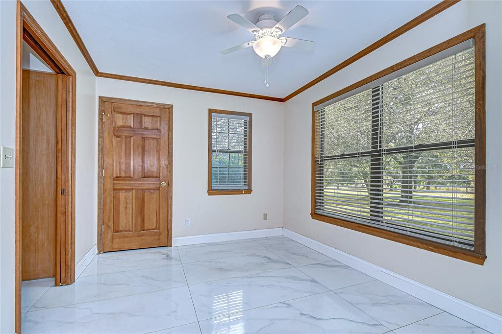 16349 Spring Valley Road Dade City, FL 33523 - Photo 22 of 40 a view of an empty room with a window and a kitchen