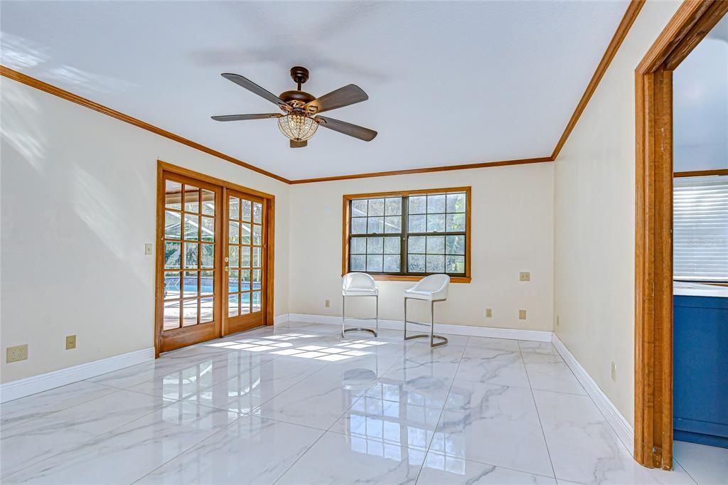 16349 Spring Valley Road Dade City, FL 33523 - Photo 23 of 40 a living room with a bed furniture and a window