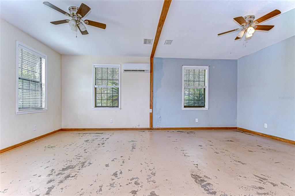 16349 Spring Valley Road Dade City, FL 33523 - Photo 33 of 40 an empty room with windows and fan