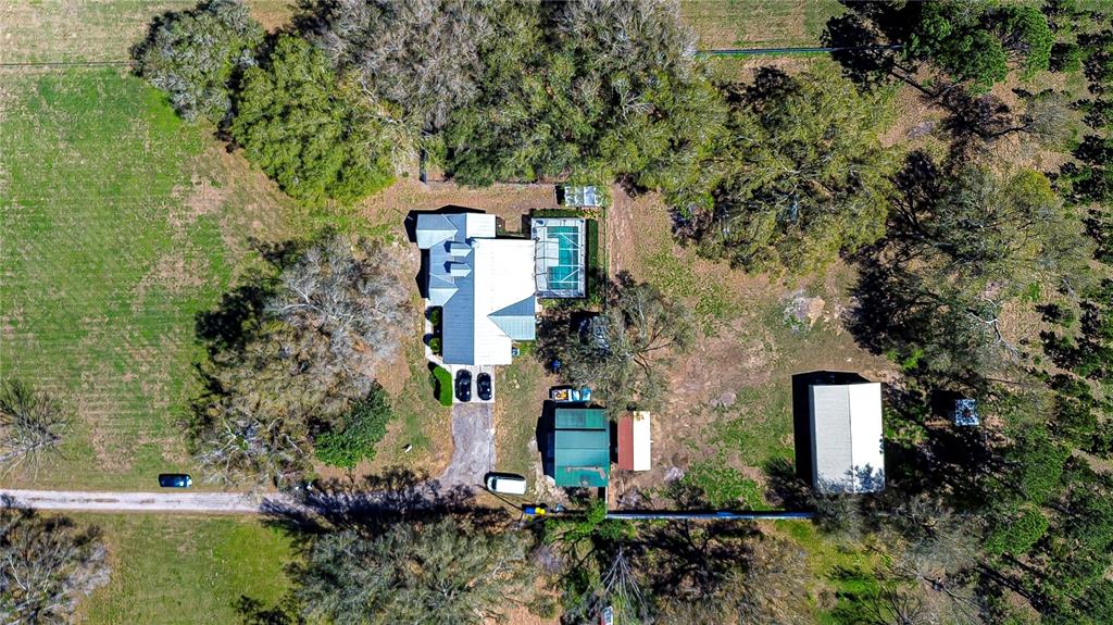 16349 Spring Valley Road Dade City, FL 33523 - Photo 4 of 40 an aerial view of a house with a yard