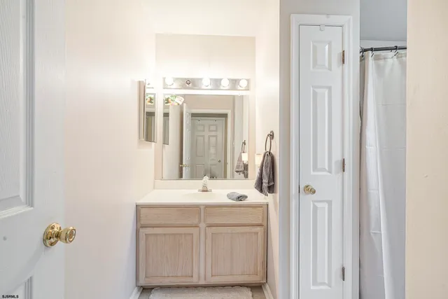 a bathroom with a toilet and a shower curtain