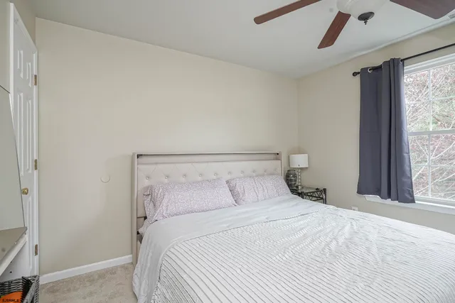 a bedroom with a large bed and a window