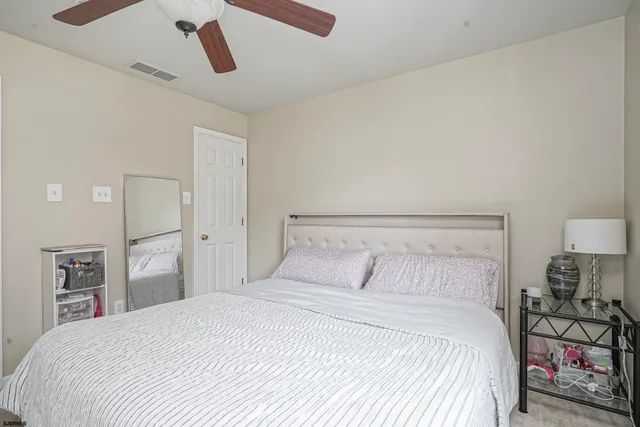 a bedroom with a bed and cabinets