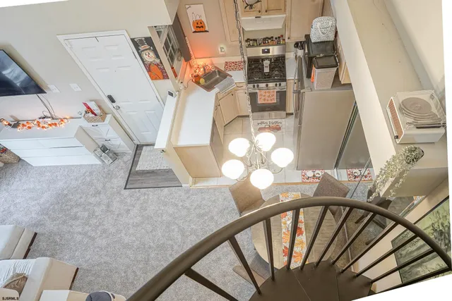 a view of roof deck with two trees and wooden fence
