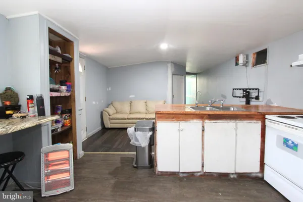a kitchen with a sink refrigerator and cabinets