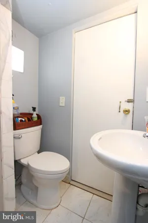 a white toilet sitting next to a bathroom sink