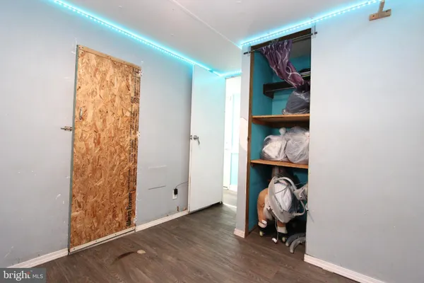 a view of bedroom with wooden floor and closet