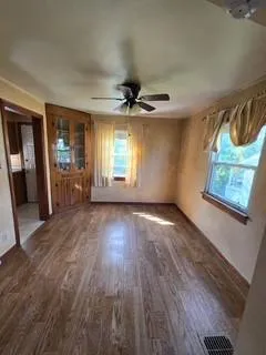 wooden floor in an empty room with a window