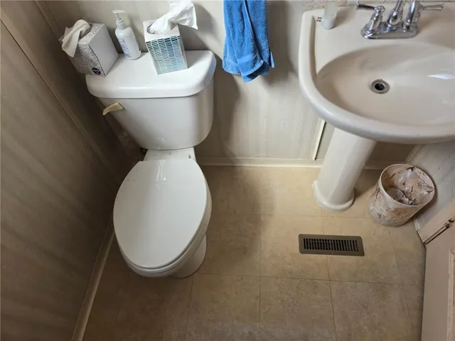 a bathroom with a toilet and a sink