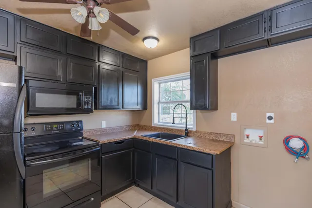 a kitchen with a sink appliances and cabinets