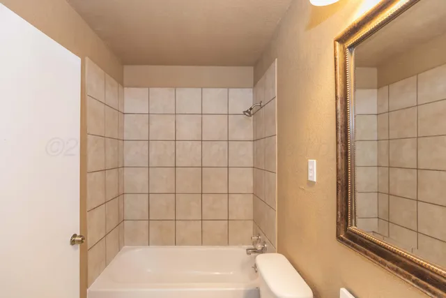 a bathroom with a bathtub and shower