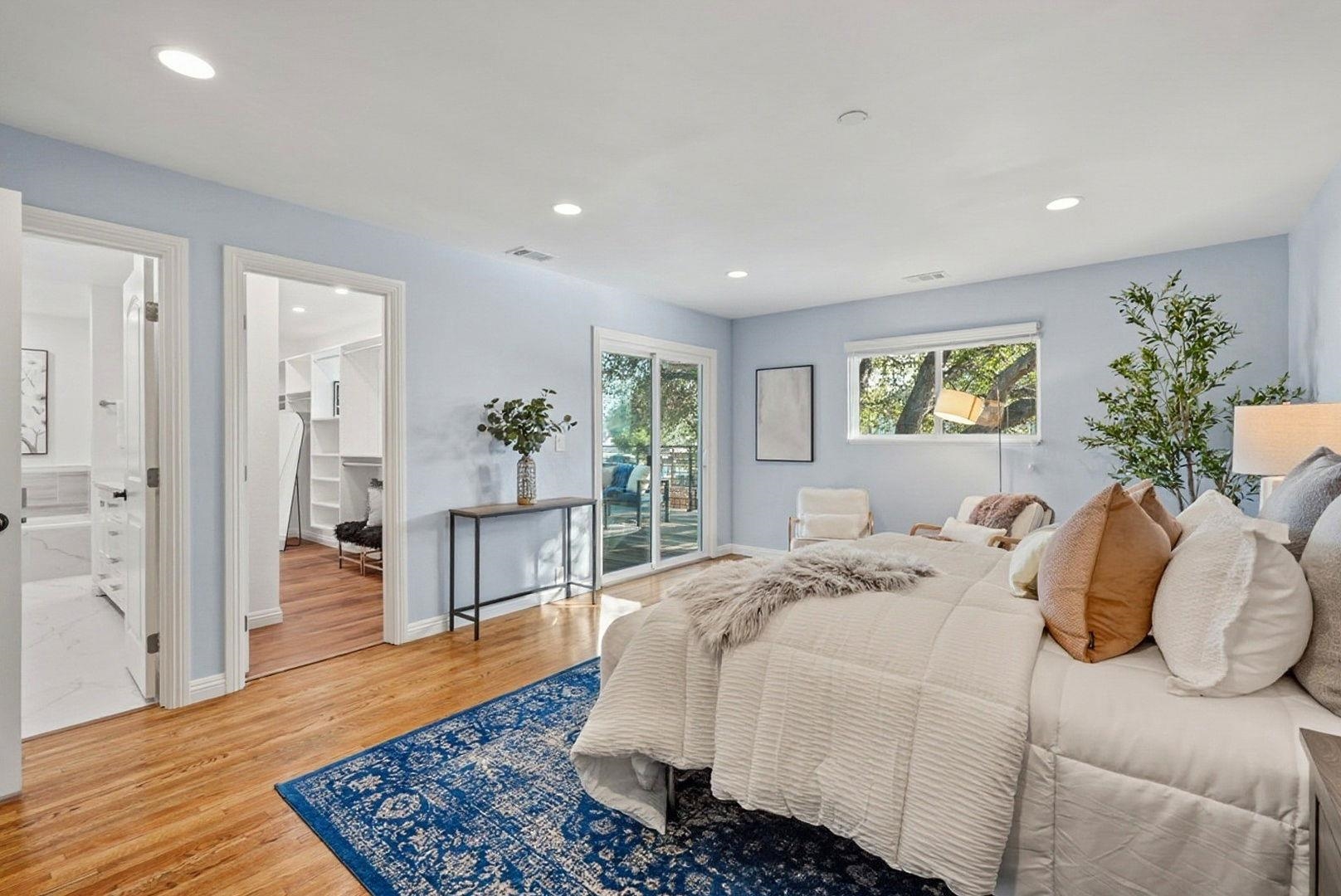 1368 Pegan Common Livermore, CA 94550 - Photo 20 of 47 a spacious bedroom with a large bed a rug and a window