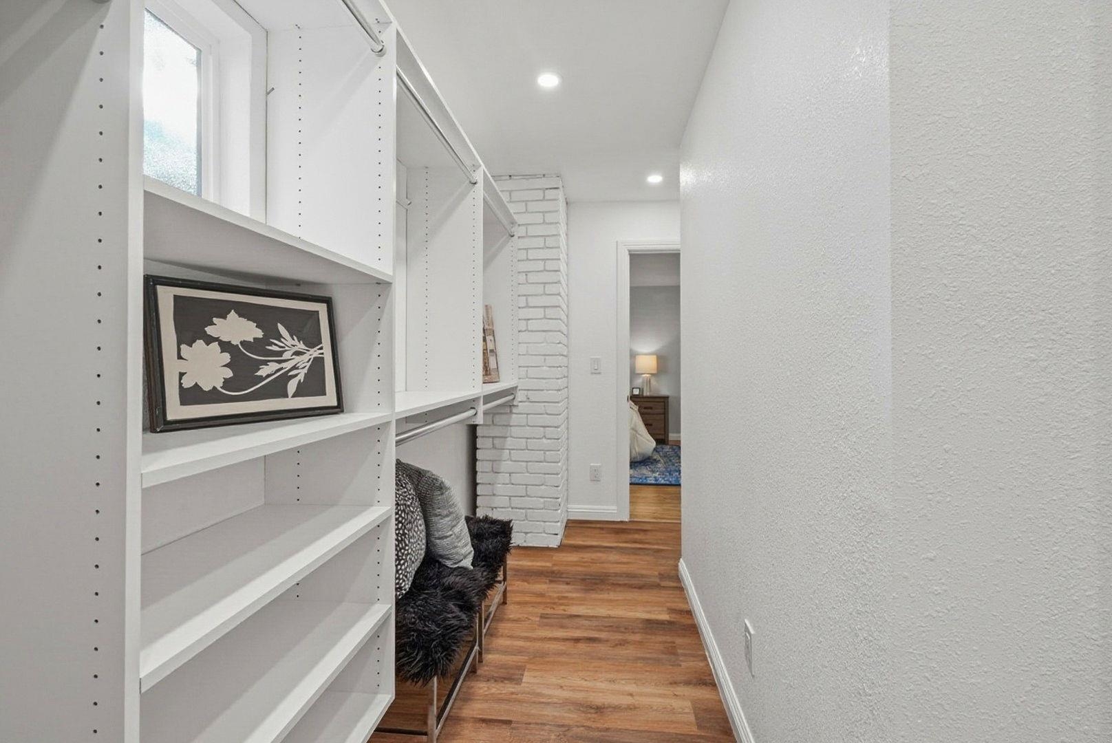 1368 Pegan Common Livermore, CA 94550 - Photo 25 of 47 a hallway with a white cabinets and wooden floor