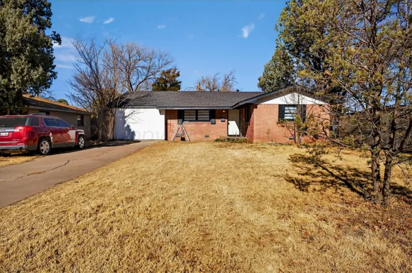 a view of a house with a yard covered in snow