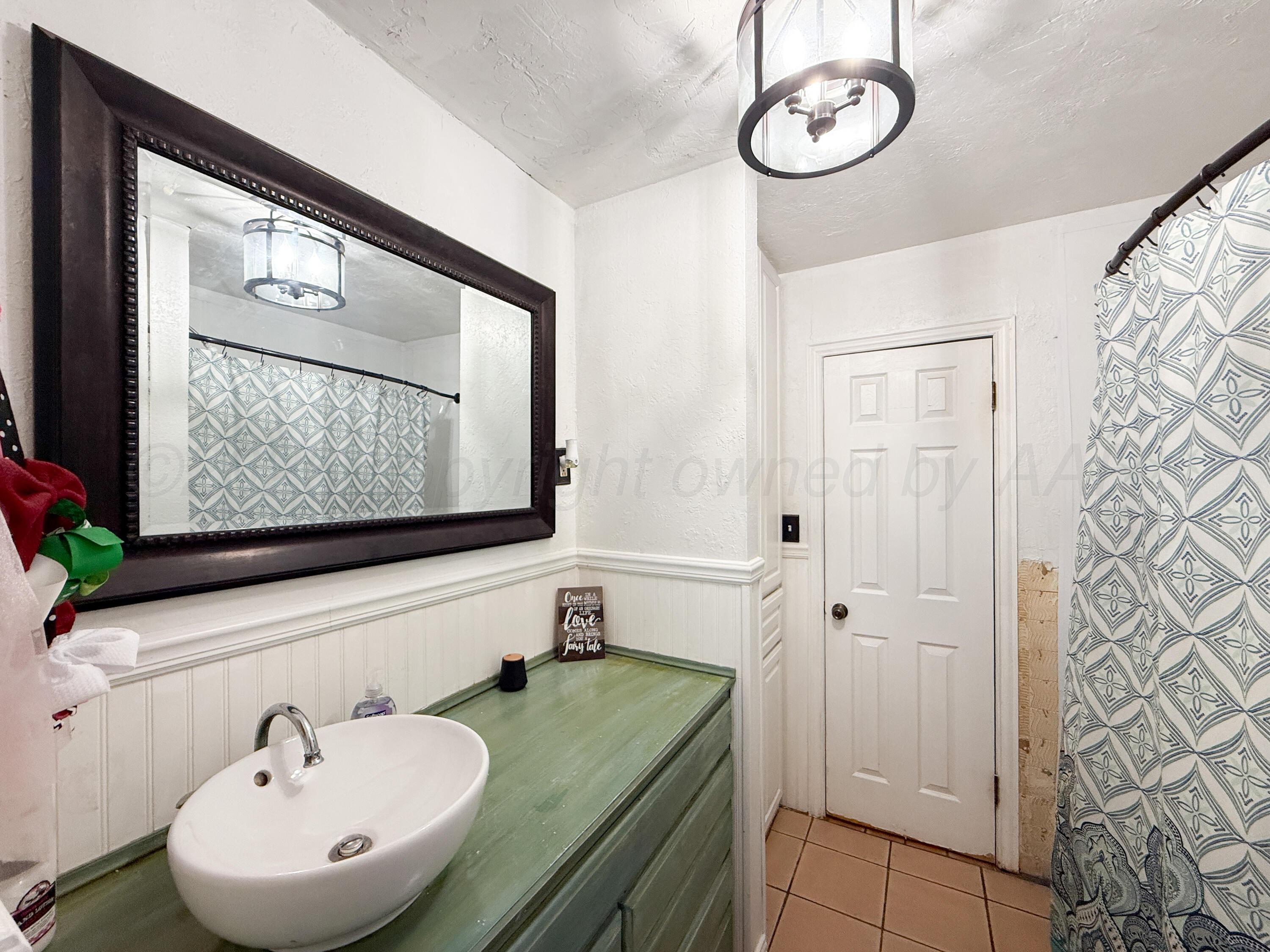 2519 9th Avenue Canyon, TX 79015 - Photo 15 of 24 a bathroom with a sink and a mirror