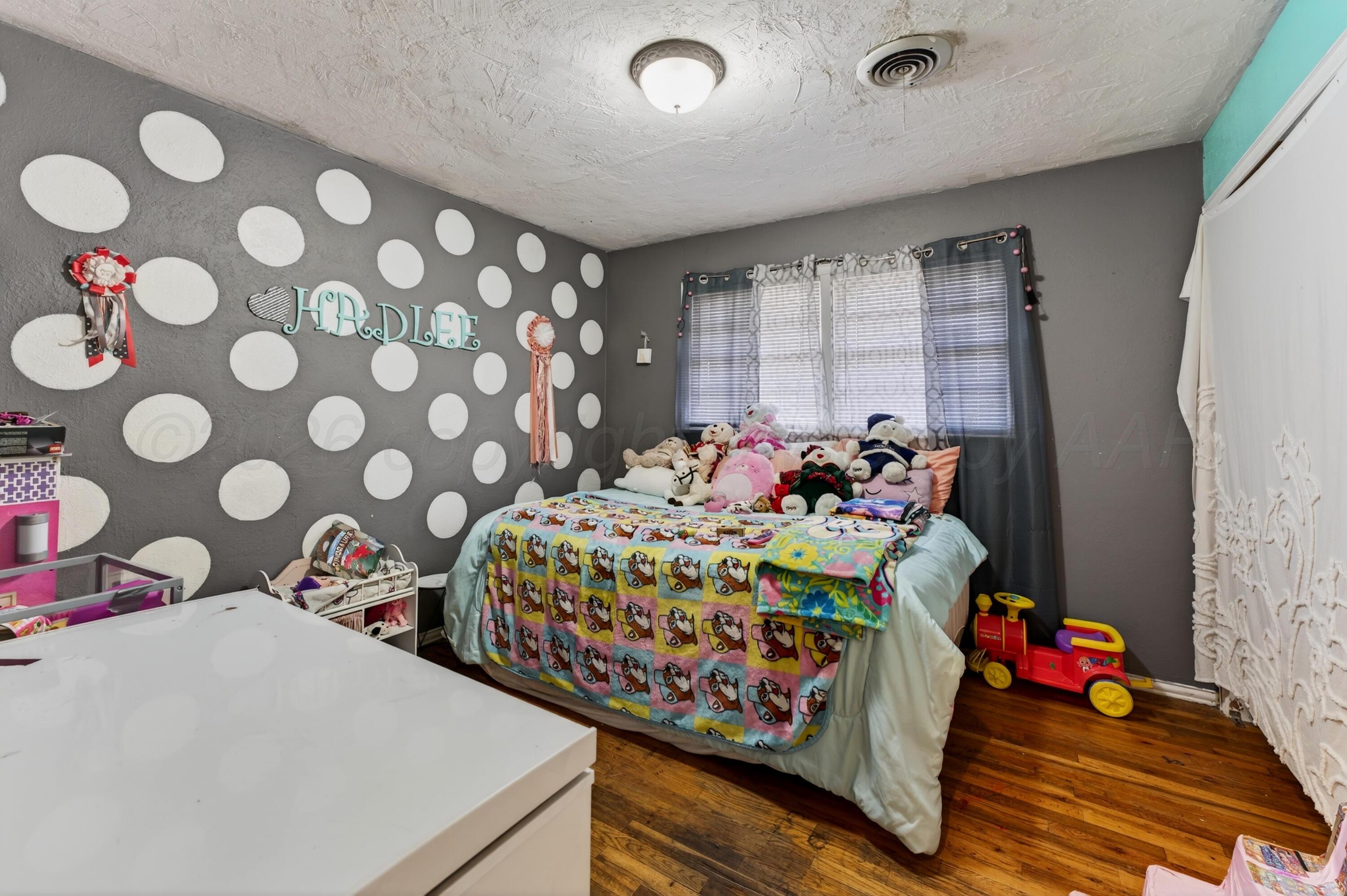 2519 9th Avenue Canyon, TX 79015 - Photo 18 of 24 a bedroom with bed and a window