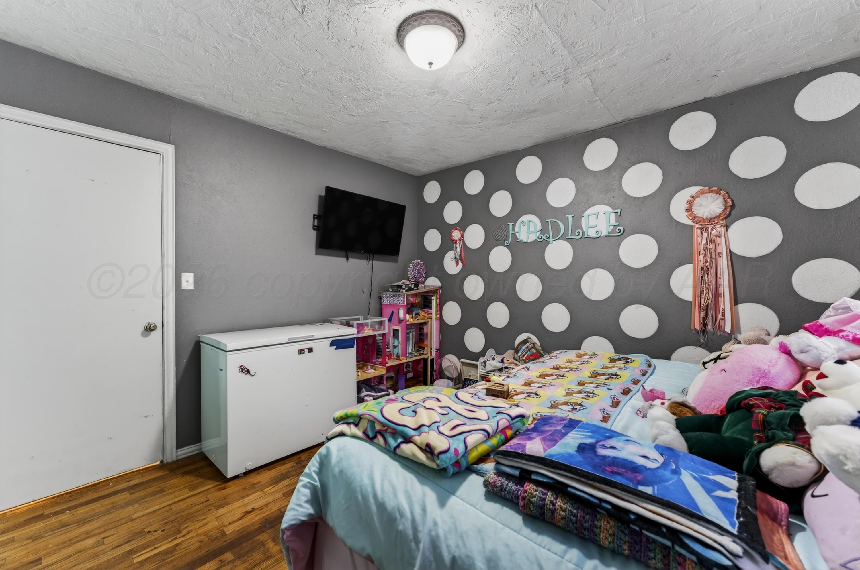 2519 9th Avenue Canyon, TX 79015 - Photo 19 of 24 a bedroom with a bed and a tv in it