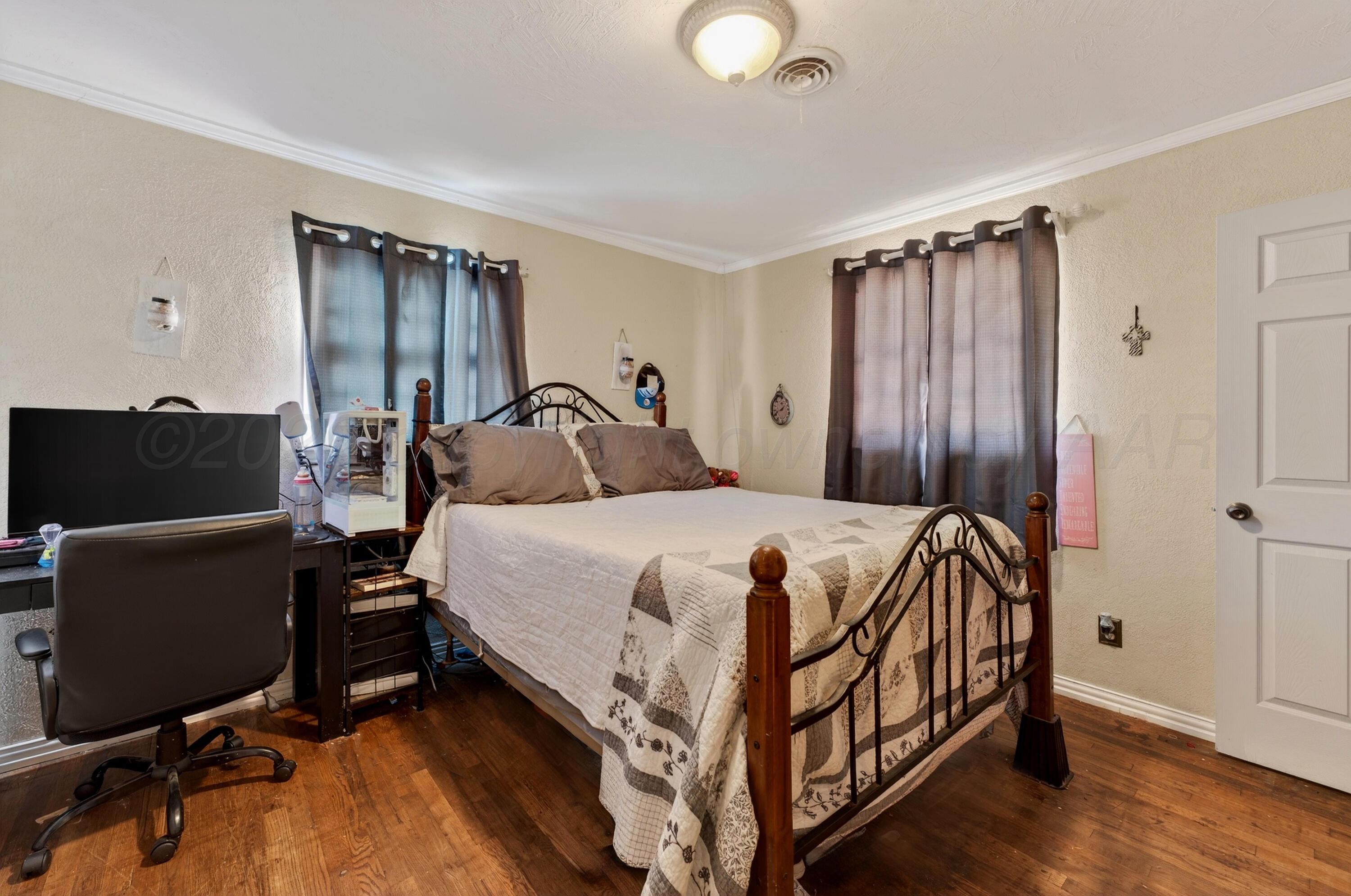 2519 9th Avenue Canyon, TX 79015 - Photo 21 of 24 a bedroom with a bed and a television