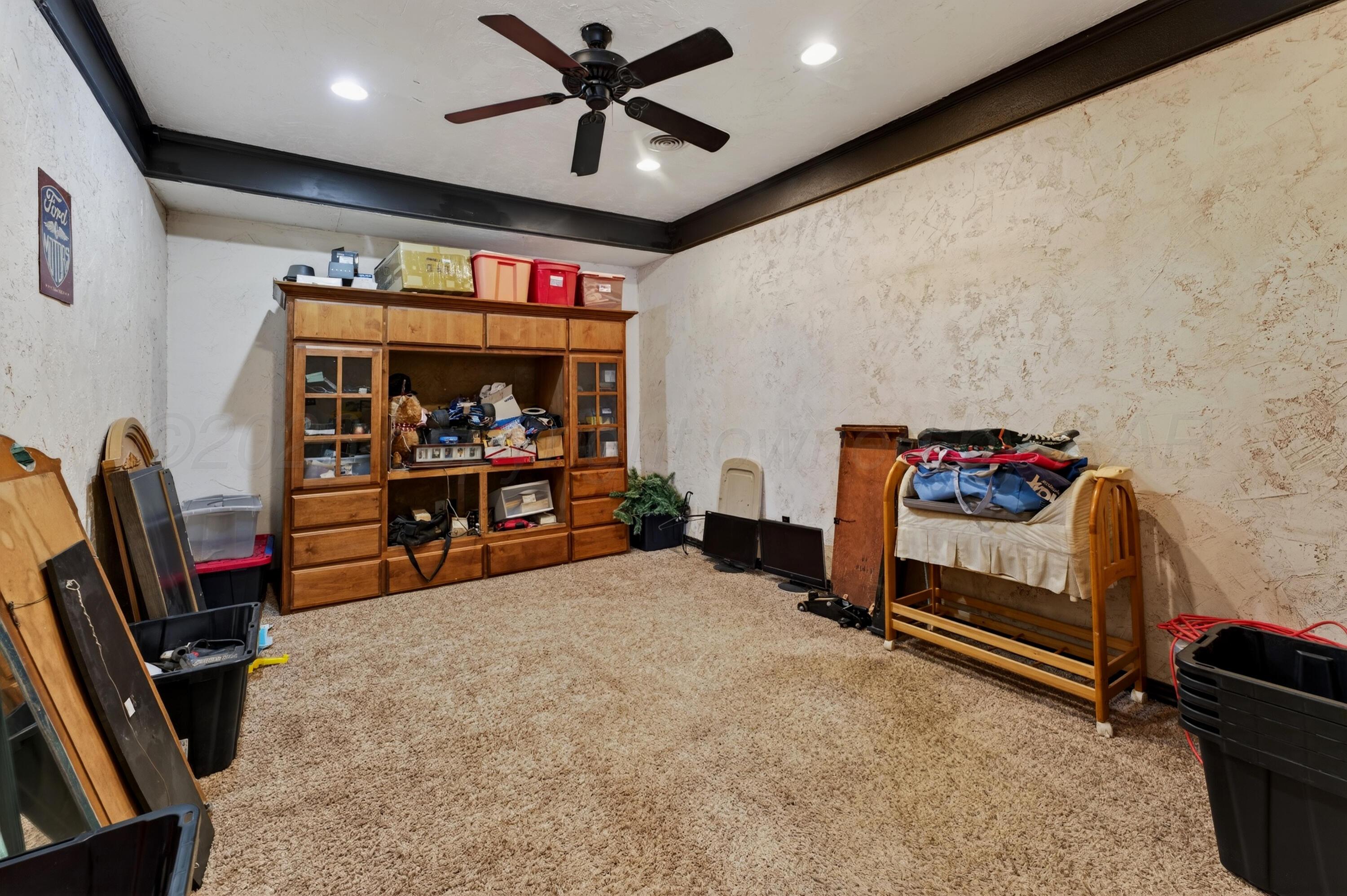 2519 9th Avenue Canyon, TX 79015 - Photo 22 of 24 a bedroom with furniture and a flat screen tv