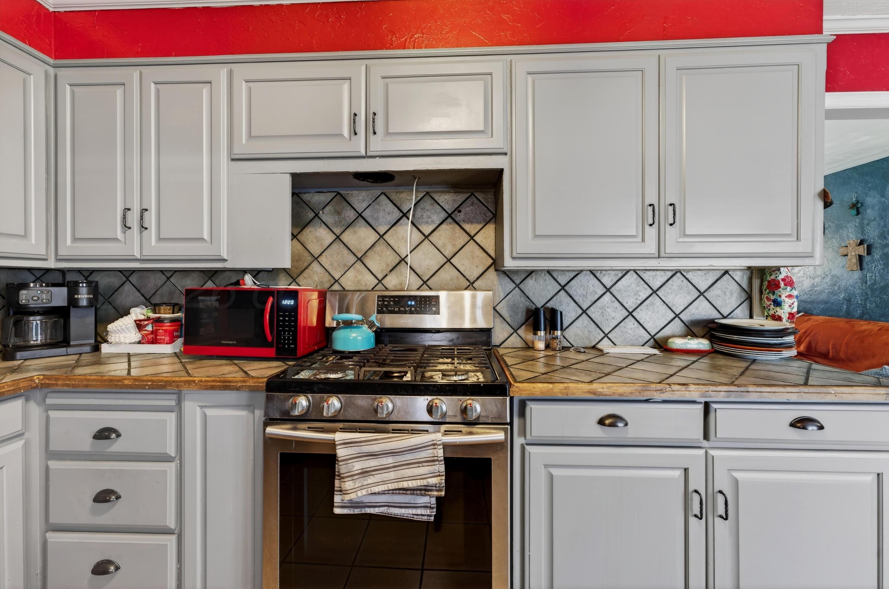 2519 9th Avenue Canyon, TX 79015 - Photo 8 of 24 a kitchen with stainless steel appliances granite countertop a stove and cabinets