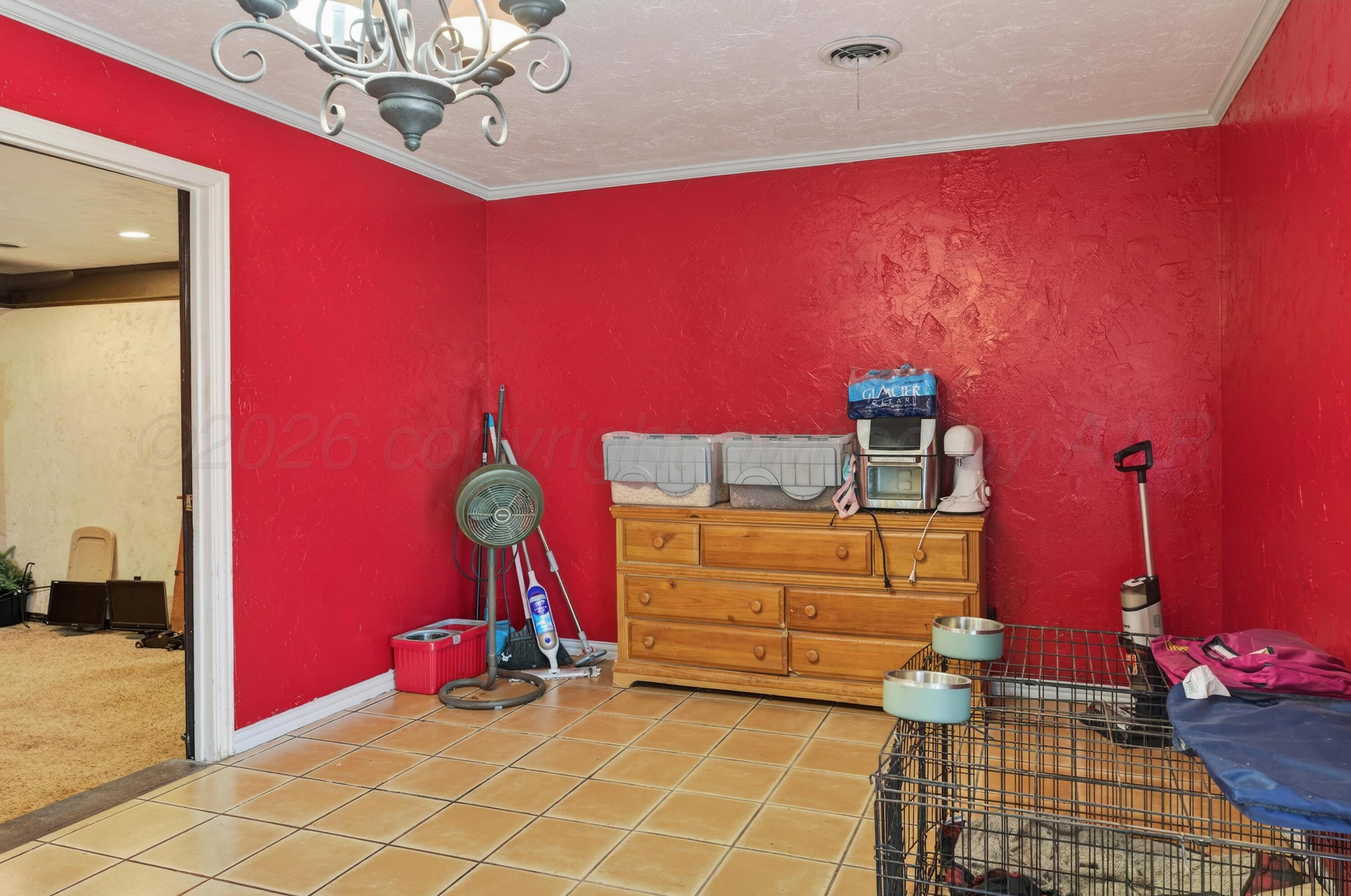 2519 9th Avenue Canyon, TX 79015 - Photo 10 of 24 a bedroom with furniture and chandelier