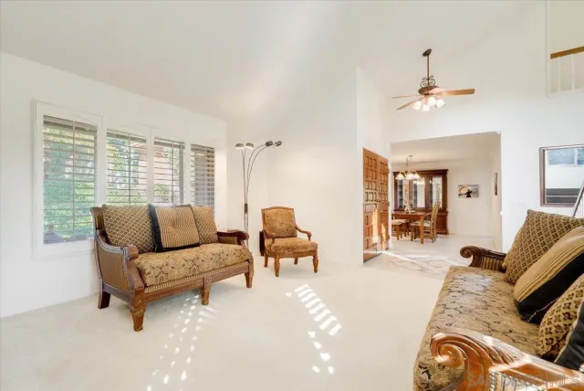 a kitchen with stainless steel appliances a refrigerator a stove a sink dishwasher with a dining table and chairs with wooden floor