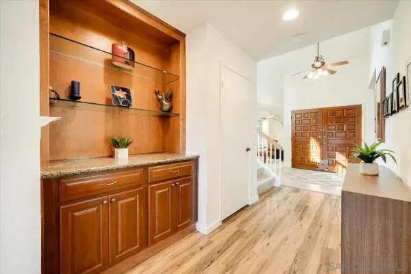 a kitchen with stainless steel appliances granite countertop a refrigerator a stove and a sink with wooden cabinets