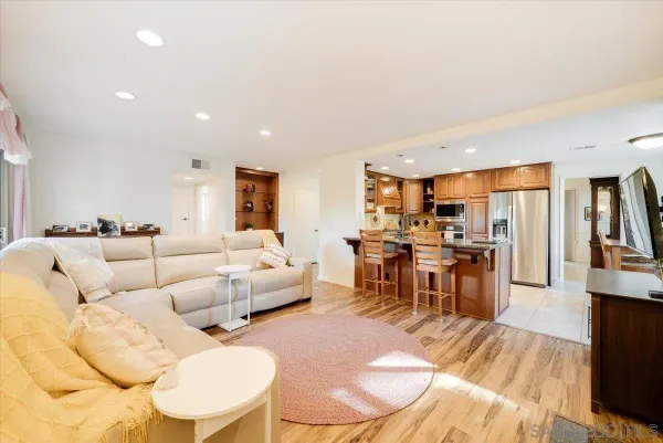 a view of a dining room with furniture wooden floor and a large window