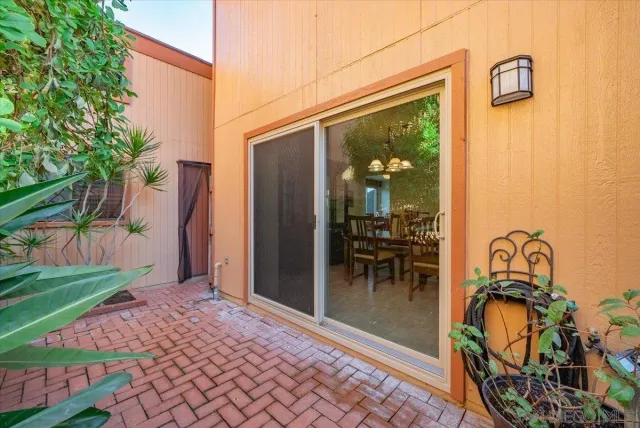 a view of a patio with table and chairs next to a yard