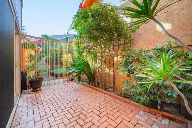 a view of a patio with couches table and chairs and potted plants
