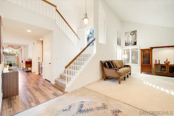 a spacious bathroom with a granite countertop sink a mirror and a shower
